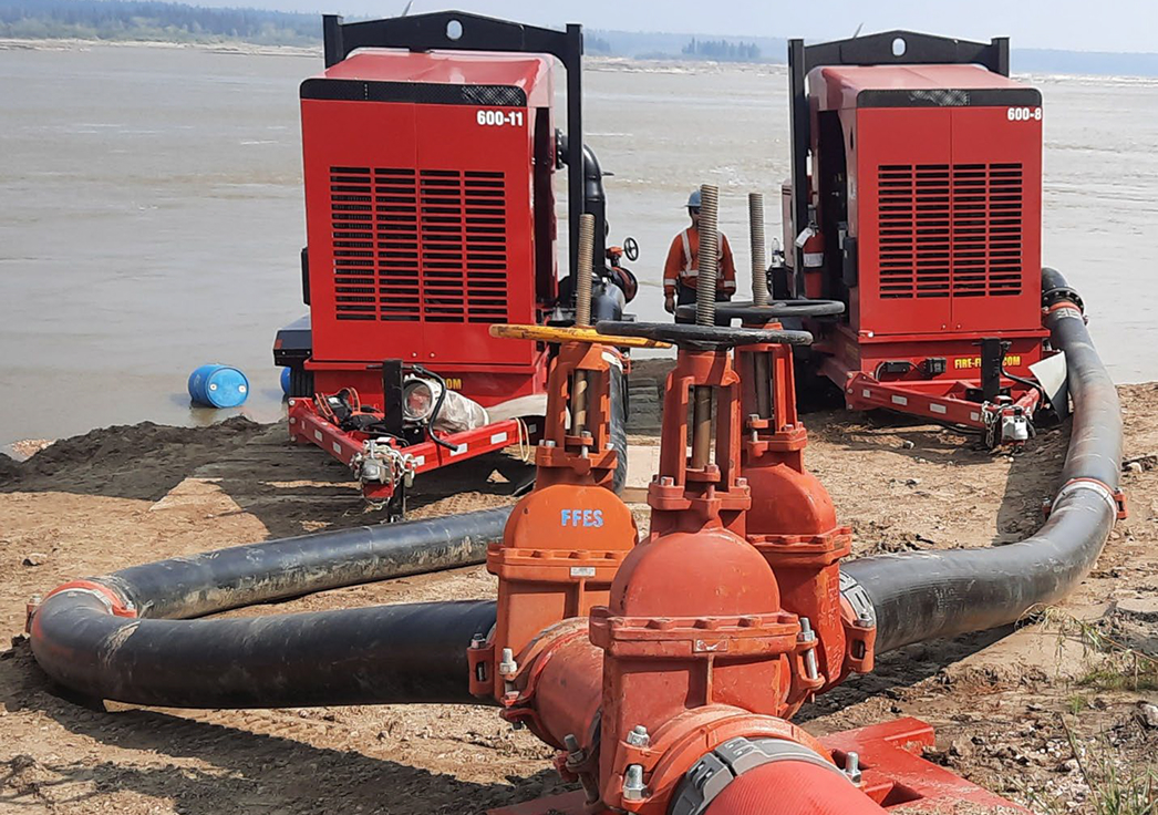 Industrial water pumps and pipes on riverbank