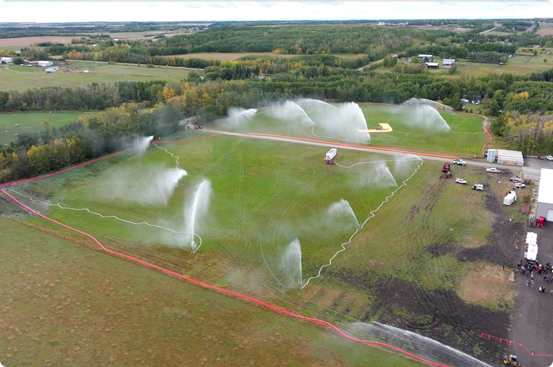 Aerial view of field with multiple water sprinklers